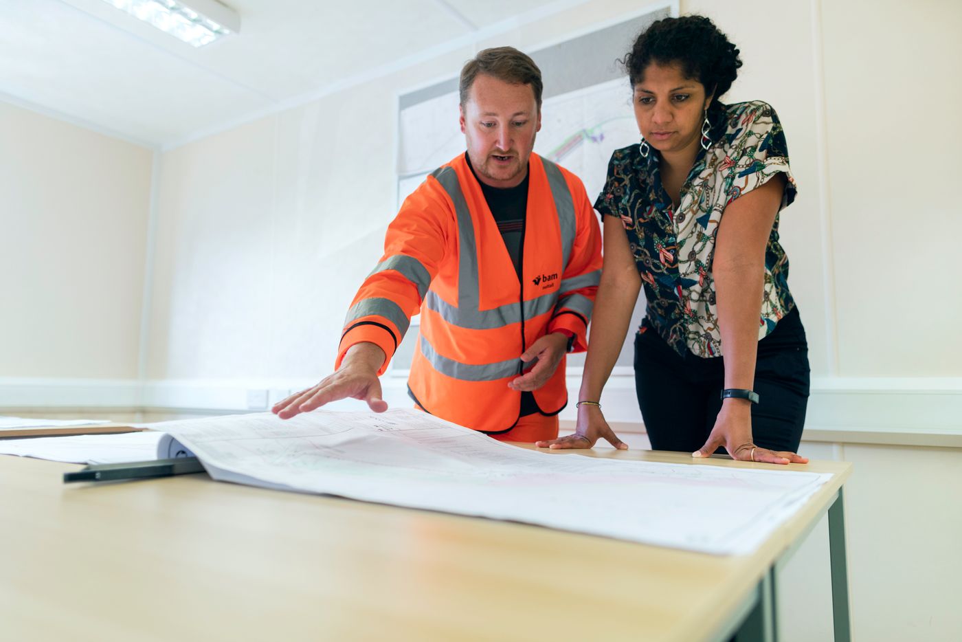 Construction Professionals Collaborating Over Project Blueprints